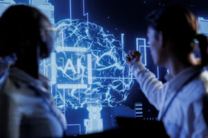 A diverse team analyzes a glowing AI brain graphic on a digital screen