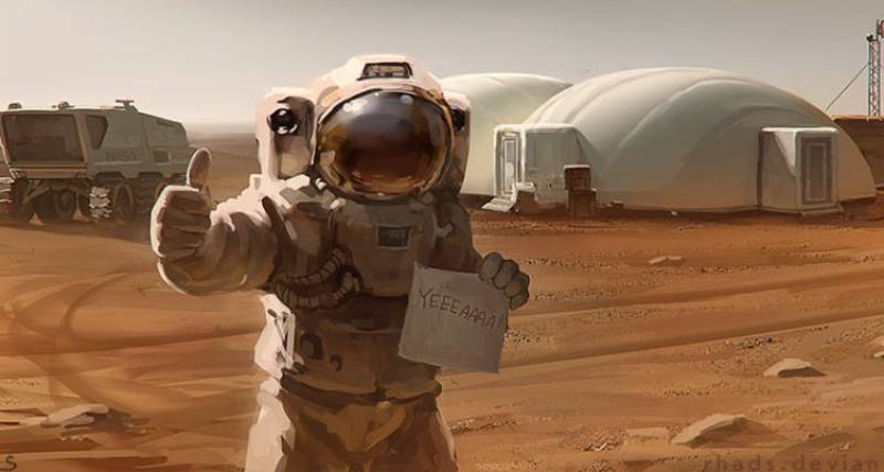 Astronaut giving thumbs up on Mars, holding a sign that reads YEEHAA, with habitats in the background.