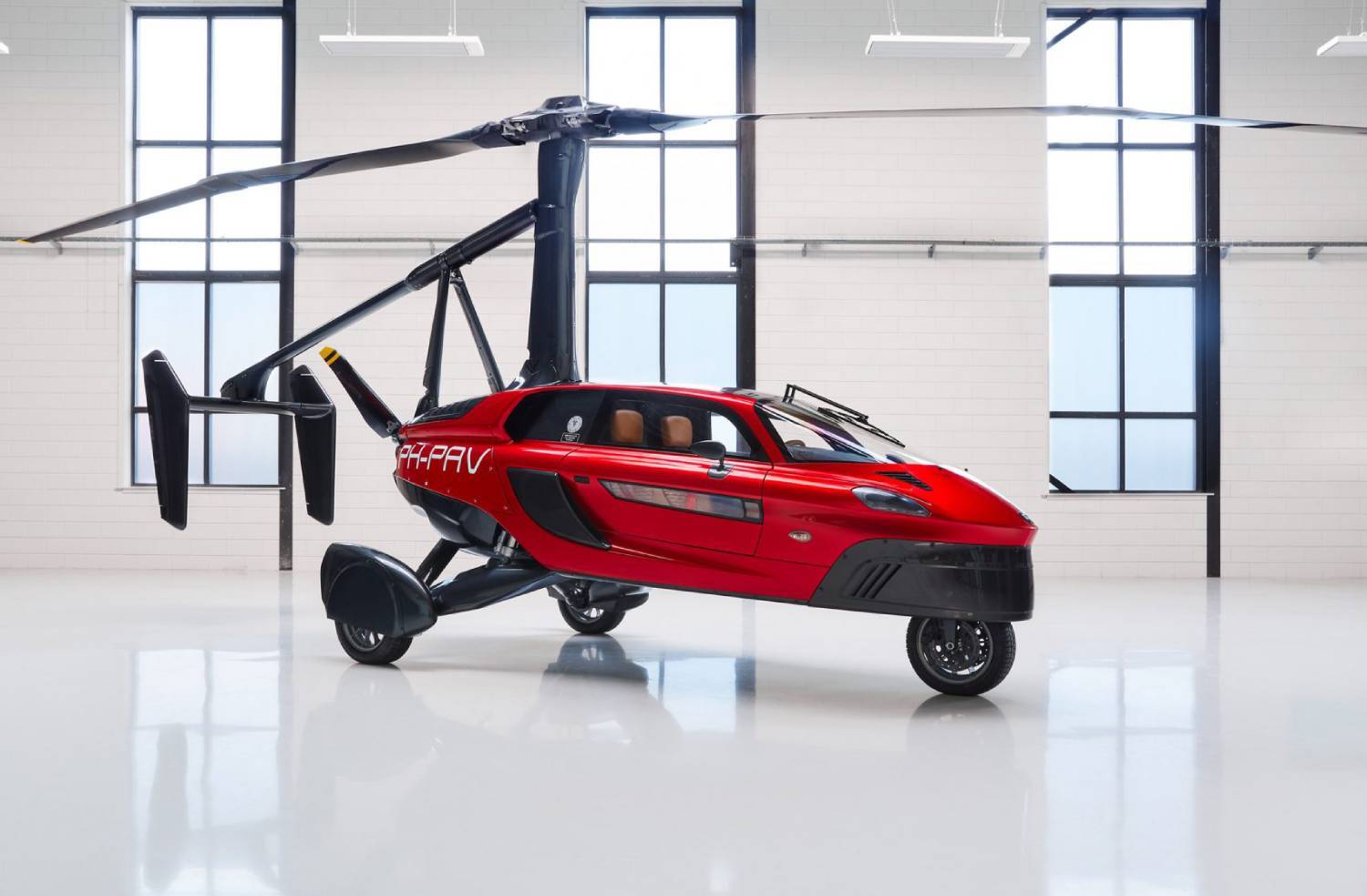 Red flying car with retractable wings and helicopter rotors