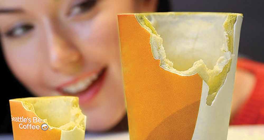 A woman smiling at edible coffee cups