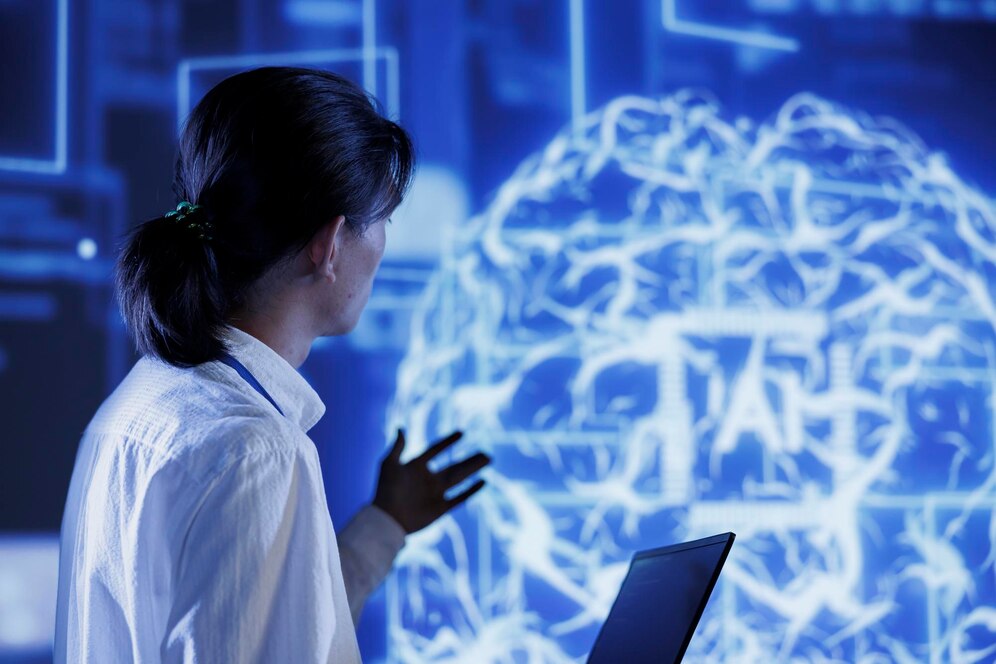 A woman examines complex digital brain graphics on a screen