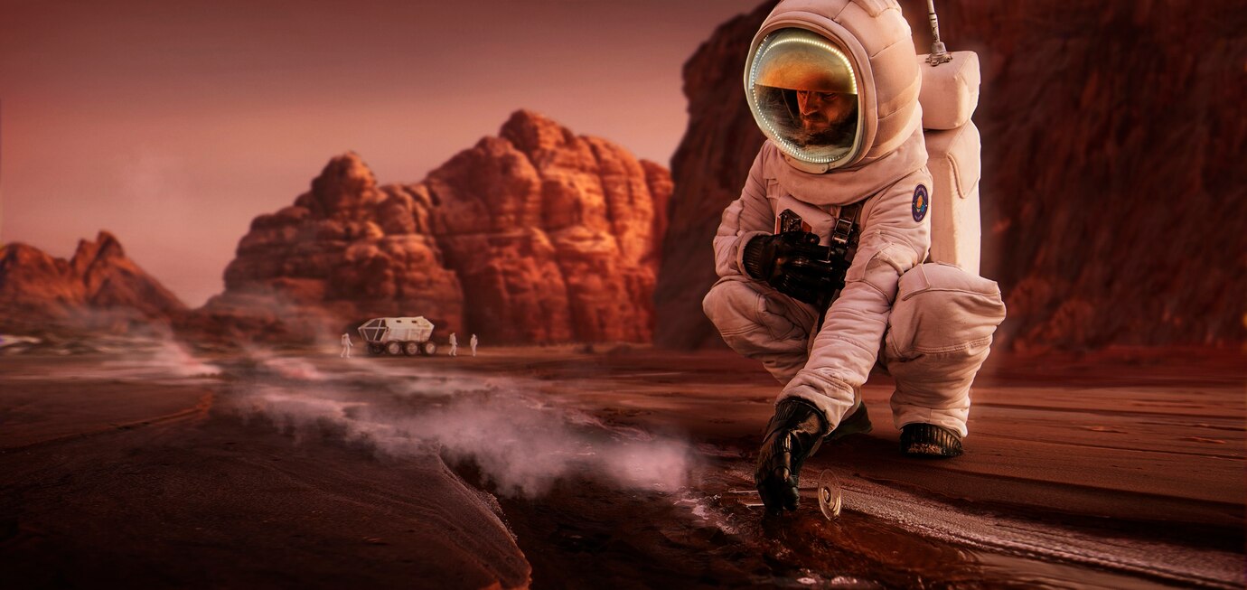 Astronaut in a spacesuit kneeling on a Mars-like surface, examining the ground, rocky terrain and rover in the background.